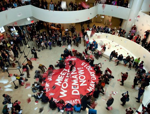Protesters unfurl a banner at New York City's Guggenheim Museum that reads "Meet workers demands now!" on May 1, 2015.